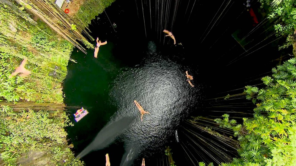 Group Cliff Dive into the Ik Kil Cenote